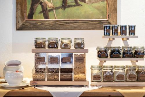 a display of jars of food on a table at Hotel Alpina Superior in Pettneu am Arlberg