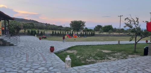 a park with a fire hydrant and a playground at Ktima Argiri in Ormos Panagias