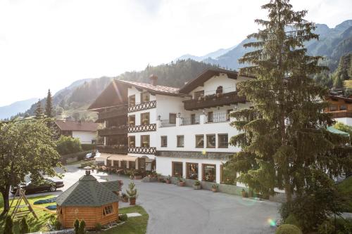 a view of a hotel in the mountains at Hotel Alpina Superior in Pettneu am Arlberg