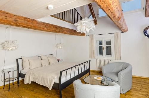 a bedroom with a bed and a glass table at Homutův statek in Kokořín