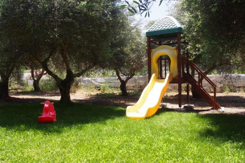 a playground with a slide in the grass at El Kona in Mixórrouma