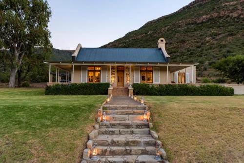 a home with a stone path leading to a house at Mount Camdeboo Private Game Reserve by NEWMARK in Graaff-Reinet