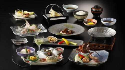 a group of plates of food on a table at Laforet Ito Onsen Yunoniwa in Ito