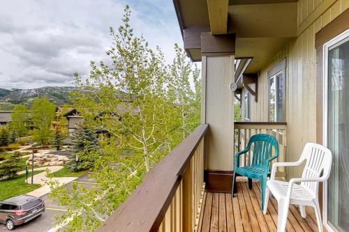 a balcony with two chairs and a view of a street at Steamboat Springs 1308 in Steamboat Springs