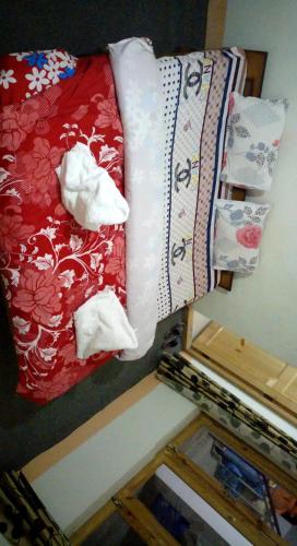 a bed with two white towels on top of it at Babu Guest House in Leh