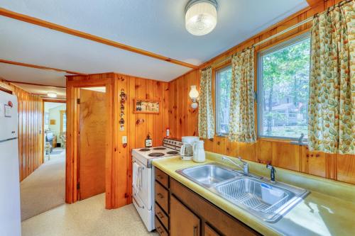 a kitchen with a sink and a stove at Quintessential Maine Cottage in Ogunquit