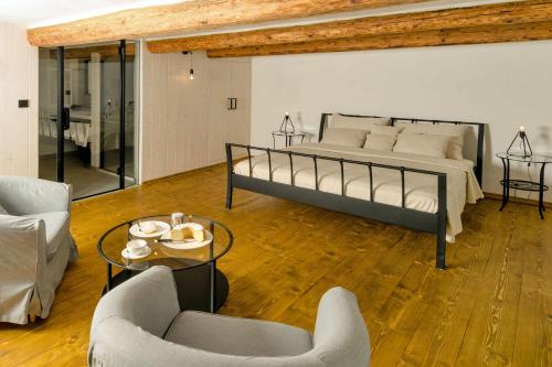 a bedroom with a bed and a table and chairs at Homutův statek in Kokořín