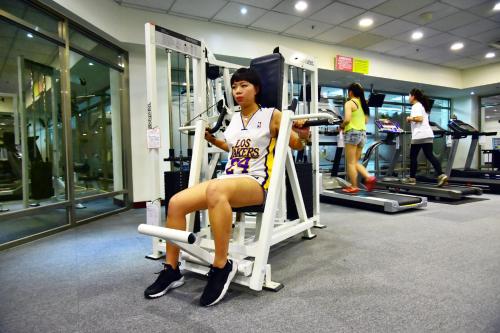 a woman sitting in a chair in a gym at Howard Beach Resort Kenting in Kenting