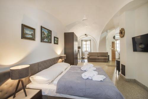 a bedroom with a bed with towels on it at Apartmány Šupina in Třeboň