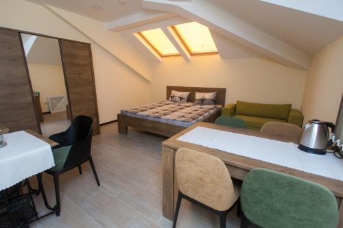 a room with a bed and a table and chairs at Sofia Family House - Free Parking in Sofia