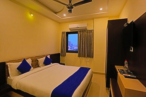 a hotel room with a bed and a window at Hotel Suraj Palace in Udaipur
