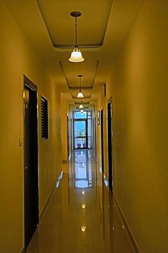 an empty hallway with yellow walls and a ceiling at Hotel Suraj Palace in Udaipur