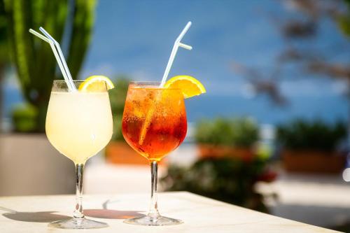 two drinks sitting on top of a table at Hotel Leonardo Da Vinci in Limone sul Garda