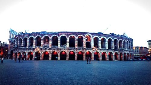 a large building with arches in a city at Italianflat - Design rooms Verona in Verona