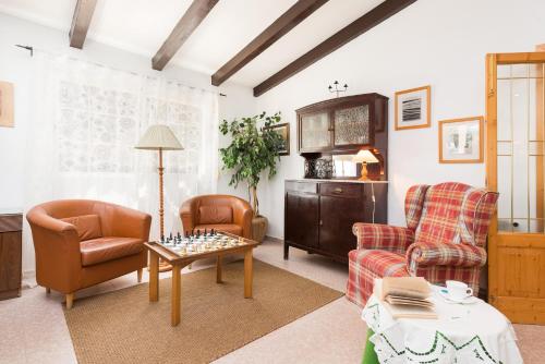 a living room with two chairs and a chess board on a table at Ca Na Sioneta in Campanet
