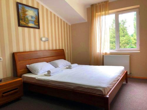 Postel nebo postele na pokoji v ubytování Park Hotel Imeri kutaisi