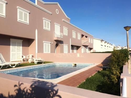 a swimming pool in front of a building at Villas King's in Albufeira