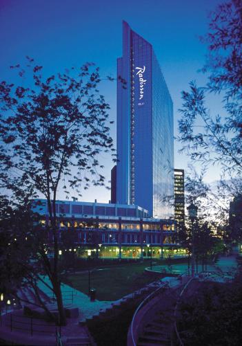 a tall building with a sign on it at night at Radisson Blu Plaza Hotel, Oslo in Oslo