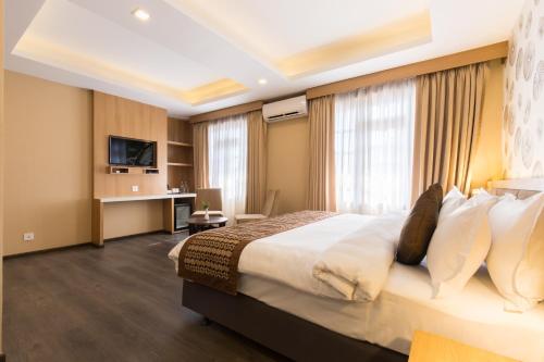a hotel room with a bed and a desk at Boudha Boutique Hotel in Kathmandu