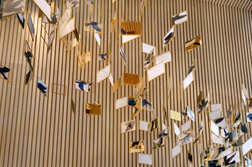 a bunch of papers hanging on a wall at Vida Emirates Hills in Dubai