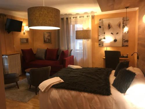 a bedroom with a bed and a living room at Auberge de la Paix in Briançon