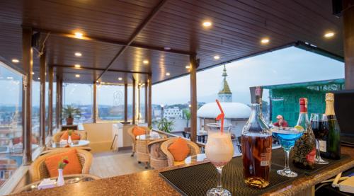 a bar with two glasses of wine on a balcony at Boudha Boutique Hotel in Kathmandu