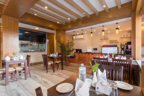 a dining room with tables and chairs in a restaurant at Boudha Boutique Hotel in Kathmandu
