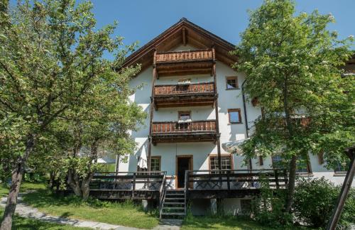 an apartment building with a balcony and trees at Hotel Ucliva in Waltensburg