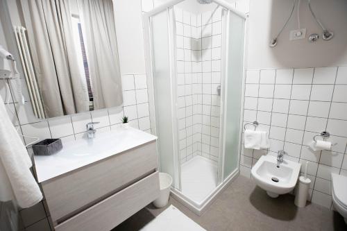 a bathroom with a sink and a toilet and a shower at Lo Stallone -Malpensa Milan airport in Buscate