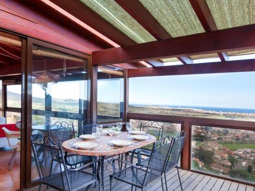 a dining room with a table and chairs on a balcony at Holiday Home Mas Ambros by Interhome in Calonge