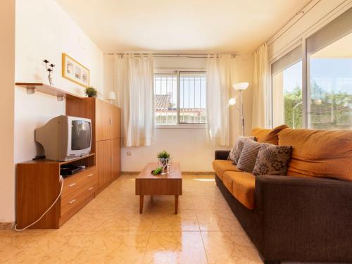 a living room with a couch and a tv at Holiday Home 3 Casas by Interhome in Riumar