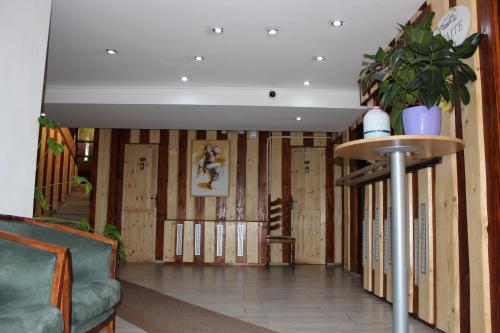 a living room filled with furniture and plants at Hotel Pod Sokolím in Terchová