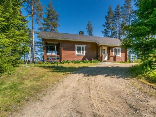 a house with a dirt road in front of it at Holiday Home Pajulintu by Interhome in Tiitanvaara