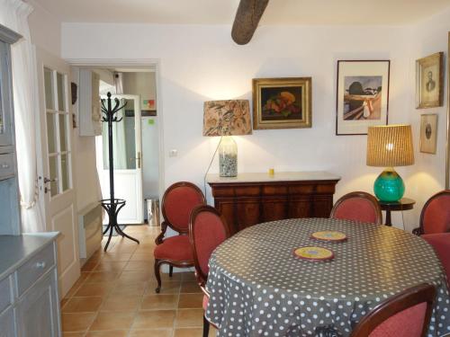 a dining room with a table and red chairs at Holiday Home Le Mazet by Interhome in Les Lecques