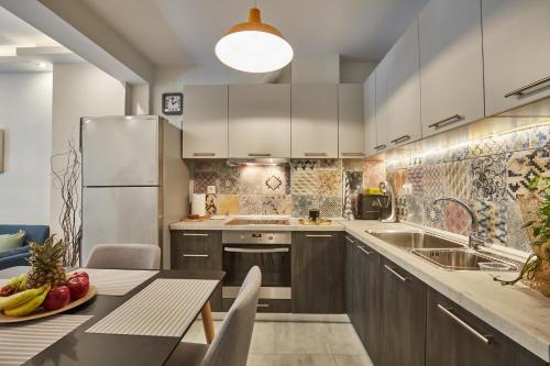 Il comprend une cuisine équipée d'une table et d'un réfrigérateur. dans l'établissement F & B Collection - Flat for 4, à Thessalonique