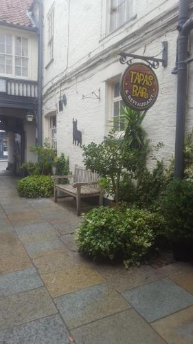 a sign for a pub with a bench in front of a building at The Bull Hotel in Horncastle