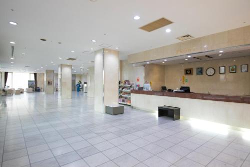 a lobby of a hospital with a waiting area and a counter at Hotel Satsukien in Kanoya