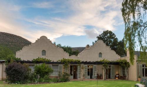 an image of a large white house at Mount Camdeboo Private Game Reserve by NEWMARK in Graaff-Reinet