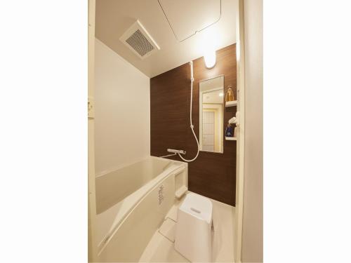 a bathroom with a toilet and a bath tub at Rinn Miyagawacho Grande in Kyoto