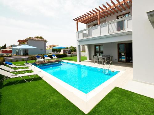an image of a swimming pool in the backyard of a house at Angie Luxury Beach Villas in Ayia Napa