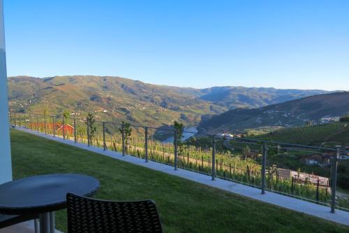 a balcony with a view of a vineyard and mountains at Casa Miradouro in Mesão Frio