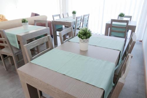 a dining room with tables and chairs with plants on them at Casa Miradouro in Mesão Frio