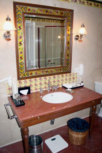 a bathroom with a sink and a mirror at The LaLit Grand Palace Srinagar in Srinagar