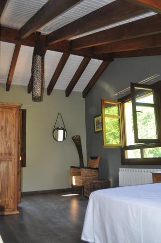 a bedroom with a bed and a window at La Casona de Palu in Pola de Laviana