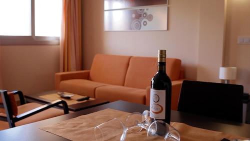 a bottle of wine sitting on a table in a living room at Albir Palace in Albir