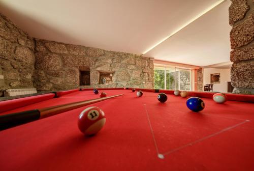 a billiard room with a red pool table with balls at Casa Panorâmica Aurora in Celorico de Basto