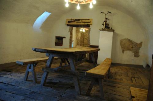 a wooden table and benches in a room at Casa Mimmo in Castiglione in Teverina