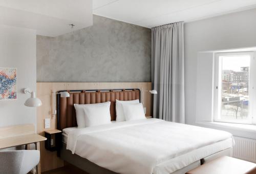 a bedroom with a large bed and a window at Radisson Blu Seaside Hotel, Helsinki in Helsinki