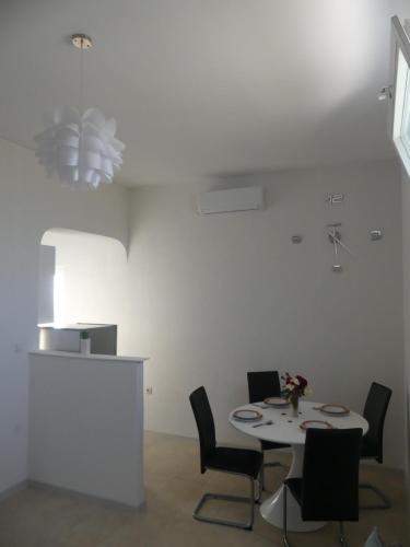 a white room with a table and chairs at Apartment Fran in Sonković