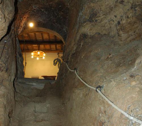 a stone tunnel with a window in a cave at Casa Mimmo in Castiglione in Teverina